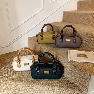 Chic retro bowling bags in four colors arranged on stairs for a stylish leather aesthetic