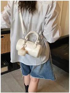 White Boston cylinder bag with 'FASHION & BAG' text and a cute alpaca plush keychain