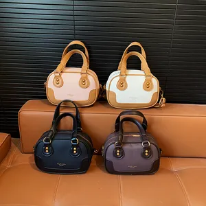 Minimalist leather handbags in pink, white, black, and coffee on a premium leather sofa
