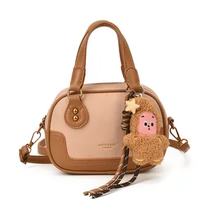Minimalist beige and brown patchwork handbag with crossbody strap and plush star charm