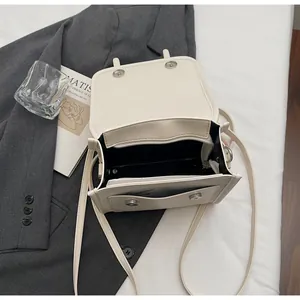 Detailed interior of a beige PU leather crossbody bag with multiple compartments