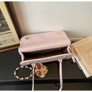 Interior view of large capacity pink shoulder bag with zipper pocket and accessories