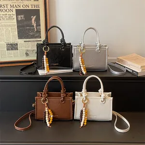 Chic knotted handle crossbody bags in four colors with bead charms and patent texture