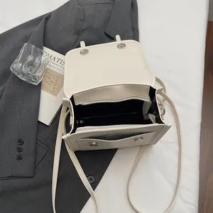 Minimalist cream white PU leather crossbody bag featuring a multi-layered inner structure