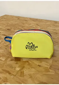 Macro view of multi-layer colorful nylon travel pouch with side handle and zipper closure