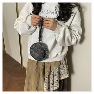 Mini portamonete a forma di cappello di paglia grigio con cordino nero e modella