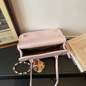 Large pale pink leather shoulder bag with magnetic closure and cute bear pendant charm