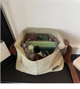 Detail view of the large canvas tote bag interior with multiple pockets and storage capacity