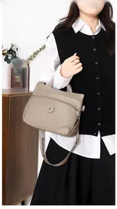 Detailed view of khaki nylon crossbody bag with wide logo strap and water-resistant fabric