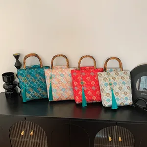 Retro Chinese style jacquard handbag with bamboo handle and elegant tassels in four colors
