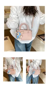 Pink lychee grain leather crossbody bag with cute teddy bear charm detail