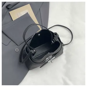 Top view of black litchi grain leather bucket bag showing interior space and silver lock