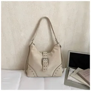 Beige vintage hobo bag with silver rivets and buckle detail for elegant daily use