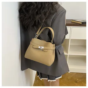 Side view of litchi grain bucket bag with metal twist lock and adjustable strap