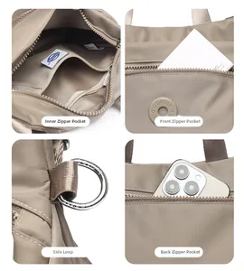 Detail view of khaki nylon bag with inner pockets, front zipper, and metal D-ring attachment