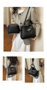 Detail view of black lychee grain leather bucket bag set with silver rotating lock closure