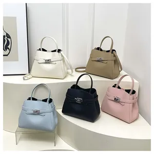 Detail view of colorful faux leather bucket bags with turn-lock metal closure and straps
