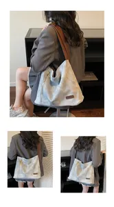 Detailed macro view of large grey tote bag featuring brown leather strap and zipper detail