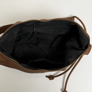 Large dark brown leather shoulder bag interior view with zipper pocket and compartments