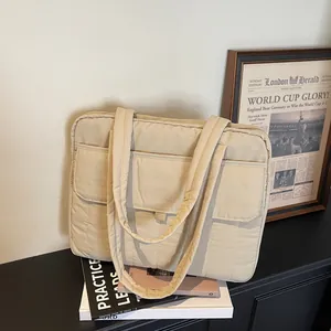 Minimalist beige quilted laptop tote bag with multiple pockets for office commute