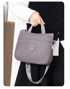 Detailed view of lilac nylon crossbody bag with adjustable wide branded shoulder strap