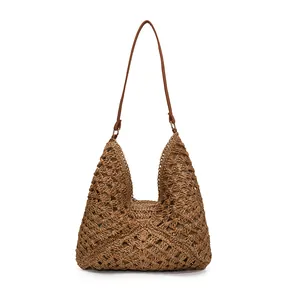 Large woven straw tote bag with floral patterns and leather strap for beach vacation