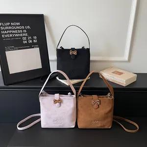 Suede embroidered bucket bags in black, pink, and brown with leopard bow accents