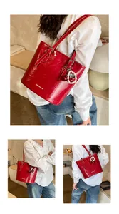 Detail of red pleated tote bag with pearl cherry pendant and fashion text branding