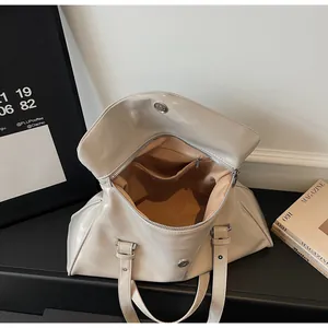 Close-up of beige tote bag interior showing the zipper pocket and spacious inner compartment