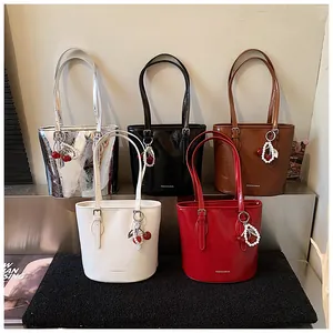 Various colors of stylish bucket bags with pearl cherry charms and long straps