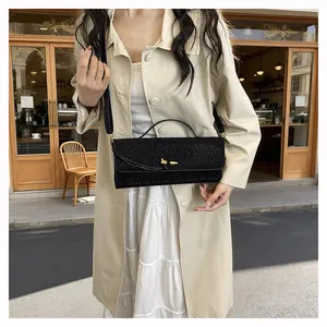Gros plan du sac à bandoulière en strass noirs avec fermoir élégant en nœud doré