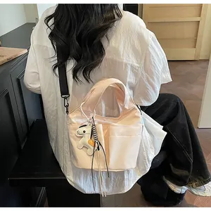 Détail du sac cabas en toile rose avec poches frontales et breloque cheval mignonne