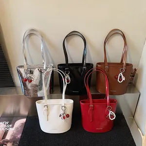 Polished faux leather bucket bags in five colors with cherry pearl charms and logo detail
