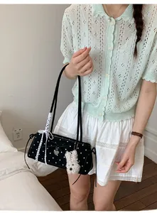 Polka dot handbag detail with lace bow, silver heart pendant and cute puppy charm