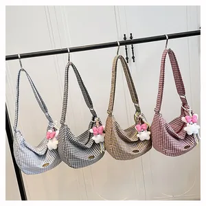 Detail of checkered crescent tote bags in four colors with cute plush bear pendants