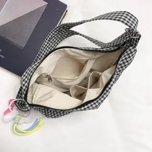 Black and white checkered canvas tote bag with a colorful plush cloud keychain