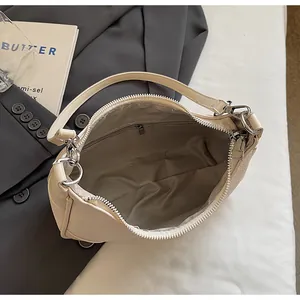 Internal view of cream pebbled leather tote with zippered pocket and wave pattern lining