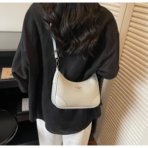 Side view of cream hobo bag with pebble leather texture and silver zipper detail