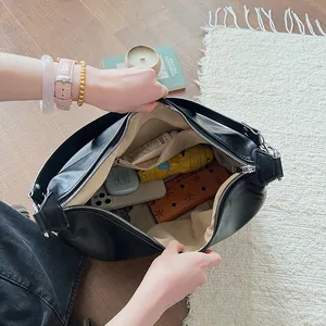 Large black PU leather tote bag with spacious interior and zipper closure for commuting