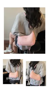 Detailed close-up of pink lychee grain leather tote bag with branded embossed logo