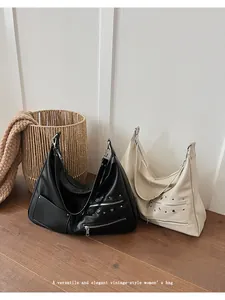 Detail of vintage-style hobo bags with metal eyelets and silver-tone hardware