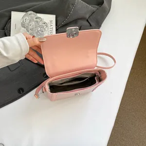 French style pale pink shoulder bag with silver turn-lock and internal storage detail