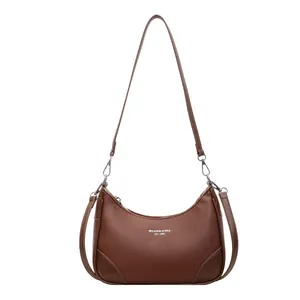 Brown lychee leather crescent shoulder bag with silver hardware and adjustable strap