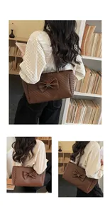 Detail showing deep brown woven tote bag with large bow and silver buckle accents