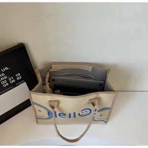 Detail showing large capacity interior of canvas tote bag with laptop and zip pocket