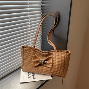 Vintage brown woven tote bag with bow detail and metal lock for daily commuting