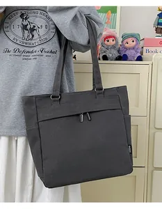 Detail of dark grey canvas tote bag with front zipper pocket and RKDBAG label