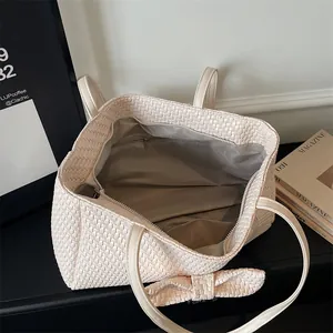 Retro cream woven tote bag with bow detail and spacious interior for daily commute