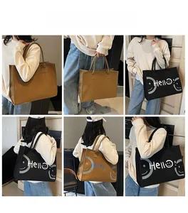 Detail shots of large capacity tote bag with Hello print in black and brown colors