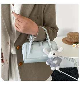 Light blue Boston bag with silver hardware and a cute puppy plush charm for work
